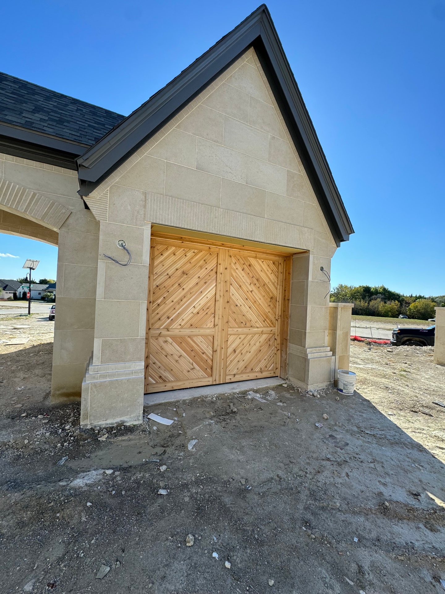 Custom wood garage door on a stone facade